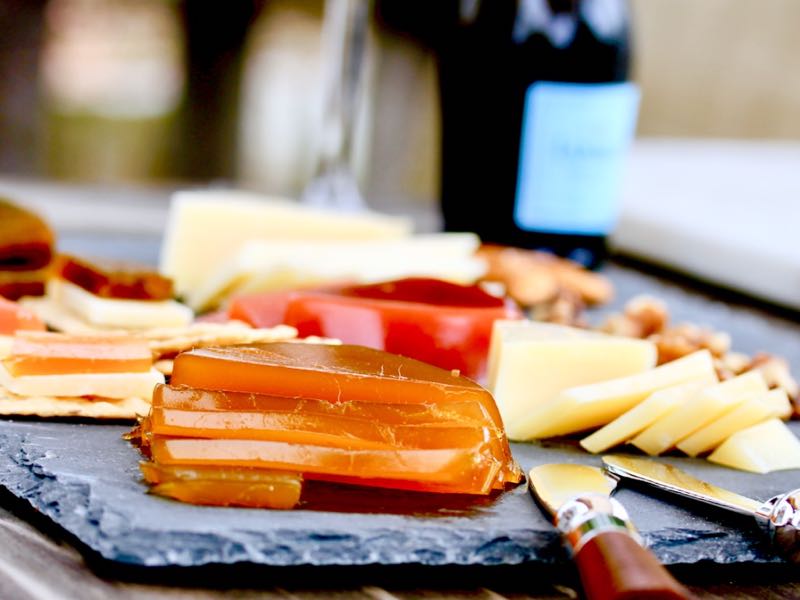 Cheese board with assorted cheeses, Hawaii Fruit Pastes and crackers. Gourmet Cheese condiments